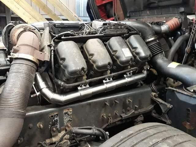 Detailed view of SUPER Racing manifold attached to a SCANIA R580 engine, highlighting industrial-grade craftsmanship