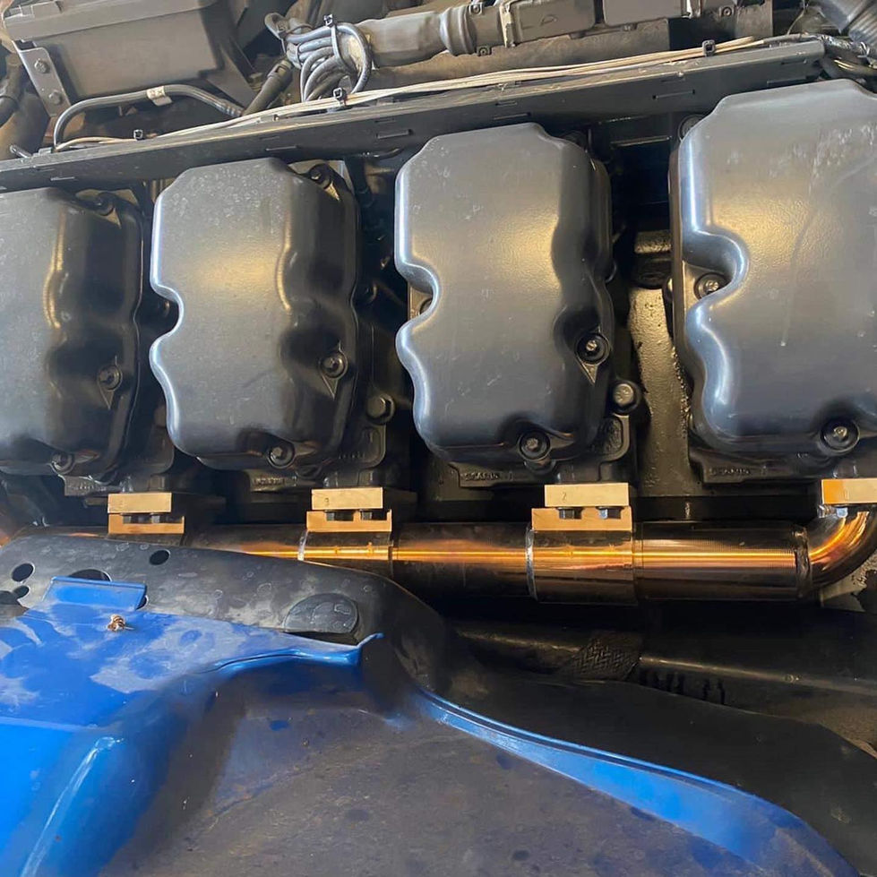 Detailed view of a SCANIA 164 engine, showcasing the manifold with a golden and blue tint developed from heat exposesure