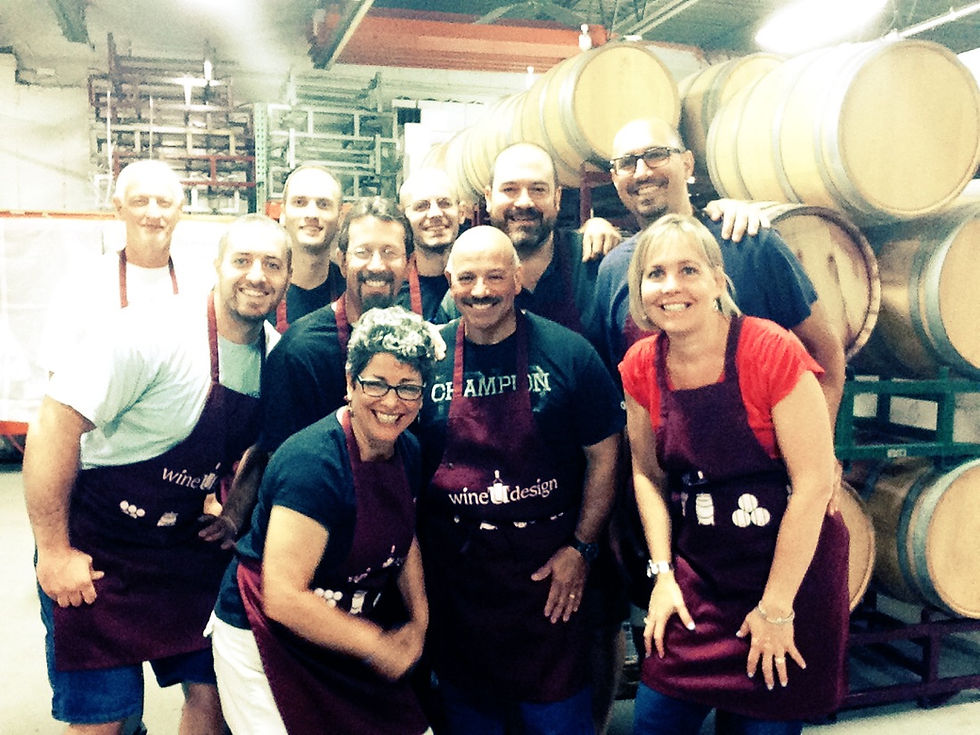 A team in wineUdesign aprons after a wine blending session in the Hicksville barrel room