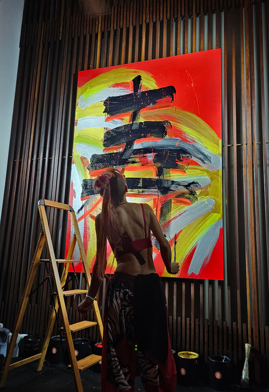 Japanese calligraphy artist Kei Murakami inspecting her finished painting at The Setai hotel in Miami Beach, FL.