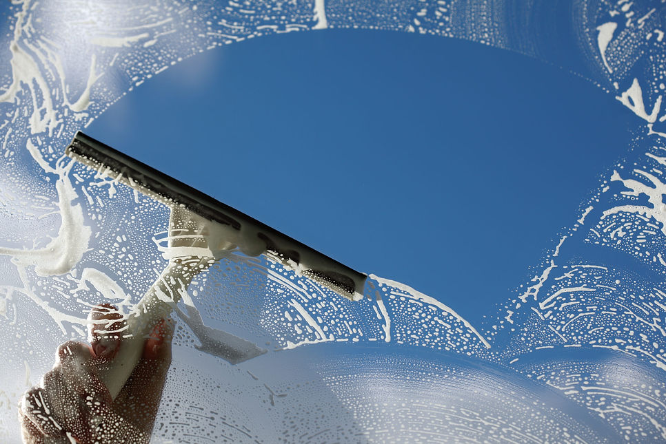 Squeegee-cleaning-window-scaled.jpg