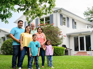 smiling-hispanic-family-outside-modern-twostory-miami-home-picture-id1210968544.jpg