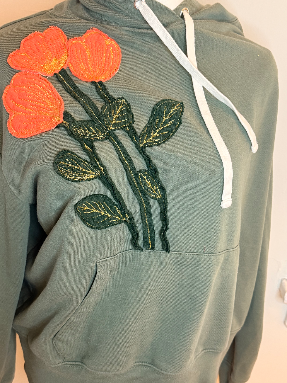 My example of Applique: The flowers, stems and leaves are applique because they are sewn on top. The leaves and flowers are all sewn around the the edge of the fabric while i decided to only sew the stems in the middle to give them a different look.