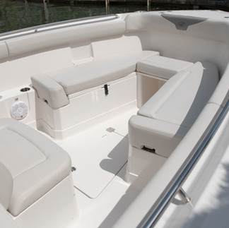 An elevated view of the 2026 Sailfish 272 CC bow seating area with clean, cushioned seats, cupholders and speakers.