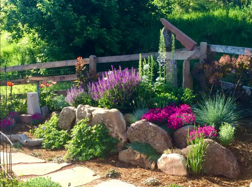 boulder wall with bright flowers 