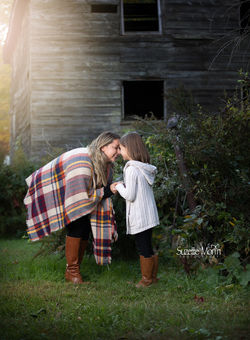 mom bending over to touch her daughters nose with her nose