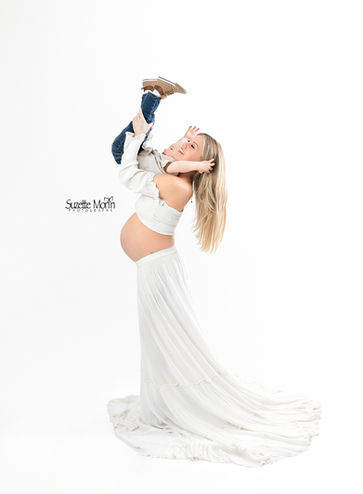 mom having fun with her son during her maternity session