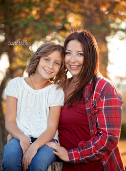 mom and daughter smiling into the camera