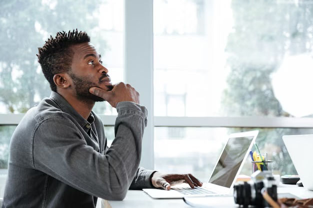 man at computer thinking