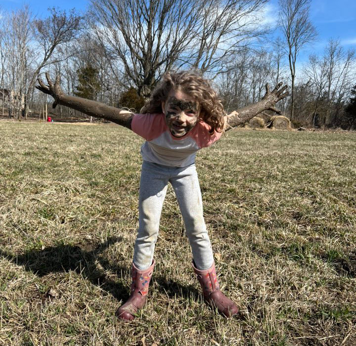 Child covered in mud after playing