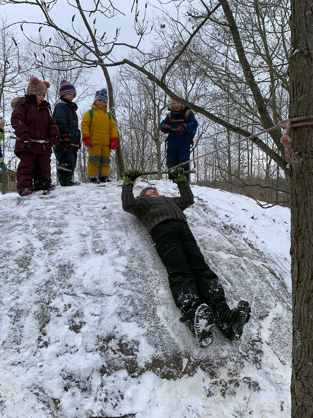 Child sliding down a snowy hill
