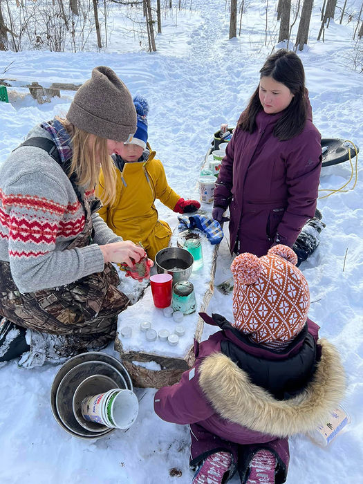 Ashley playing with children in snow