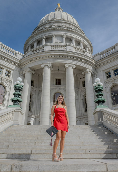 Amelia Pantazon standing with graduation cap in from of Wisconsin state capital