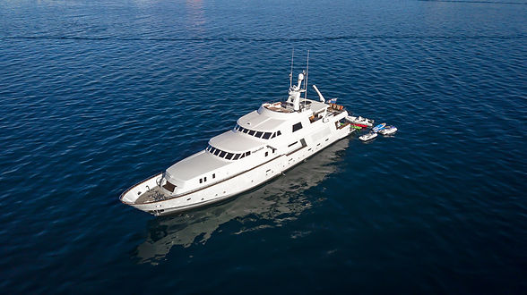 White yacht floats on the ocean; aerial view of Viento Sur Charters.