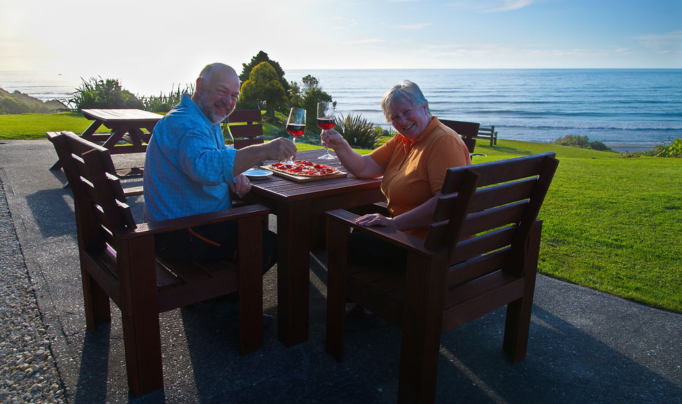 Guests Enjoying a homemade Pizza and Wine- Breakers Boutique Accommodation- Overlooking the Sea