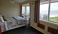 Koromiko Room with queen bed and coastal views at Breakers