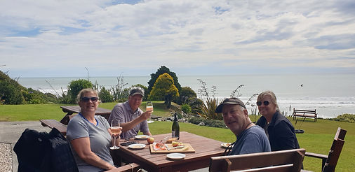 Guests enjoying gourmet outdoor dining at Breakers Boutique Accommodation overlooking the