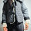 Miniatura: Woman wearing a quilted jacket with bow detail and white fringe cuffs.