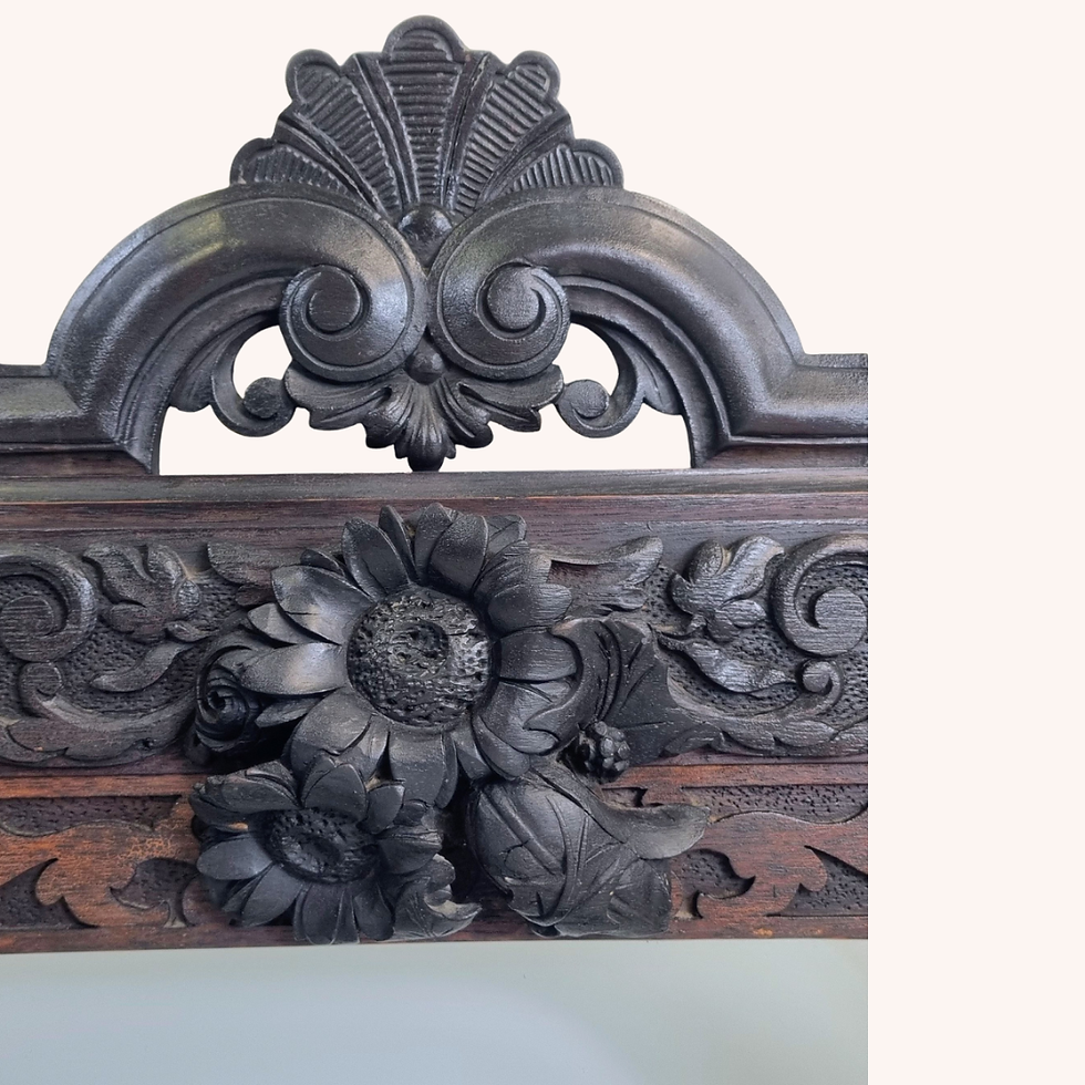 Carved Gothic-style wall mirror with floral and scroll details.  Suggested UK Price Range