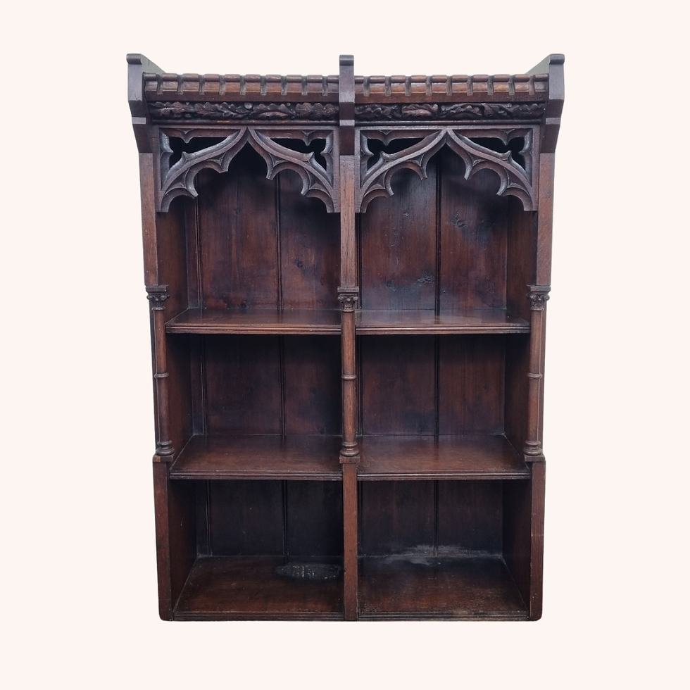 Victorian Gothic oak bookcase with carved tracery, leaf frieze and castellated top.