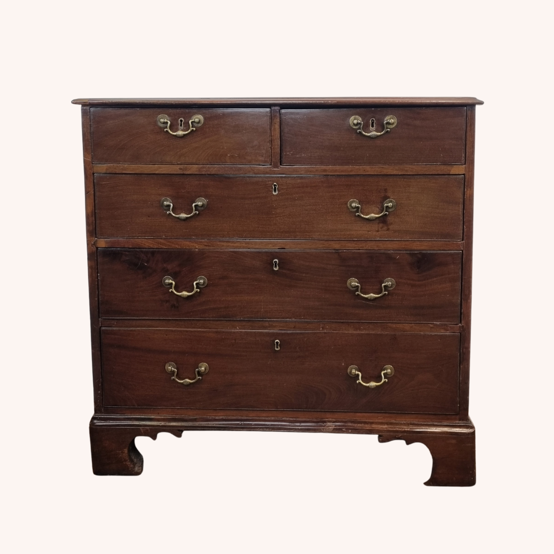 Late Georgian mahogany chest of drawers with brass handles and bracket feet, showing graduated drawer fronts.