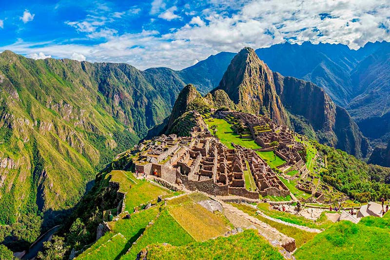 Machu Picchu citadel with stone terraces and mist-covered peaks, showcasing Peru’s rich Incan history.