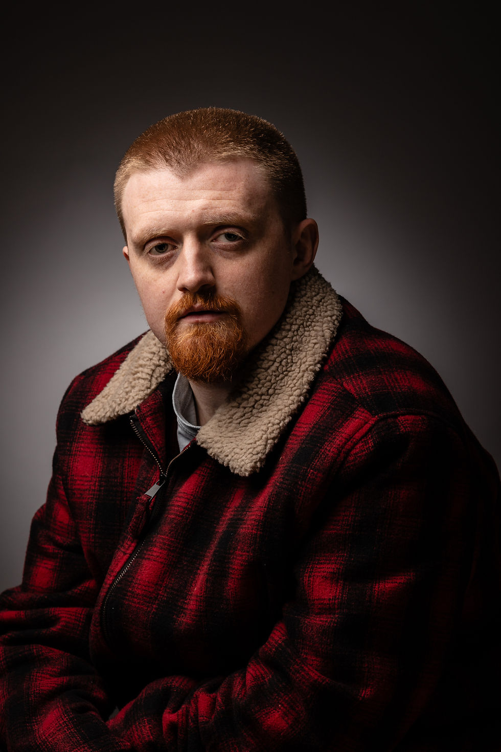 Man with red beard in plaid jacket