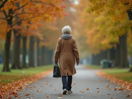 A senior woman walking outdoors on a peaceful trail during fall