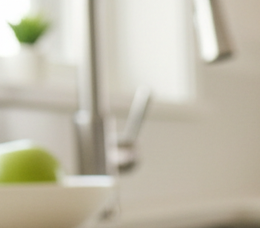 Close-up view of an older adult placing one hand on a kitchen counter for balance.