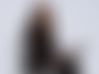 Woman wearing black suit with a laptop