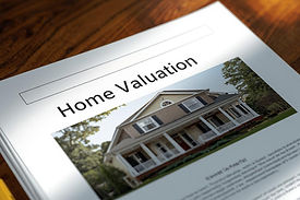 Create a report sitting on a tabletop with a picture of a home on it, and the title should