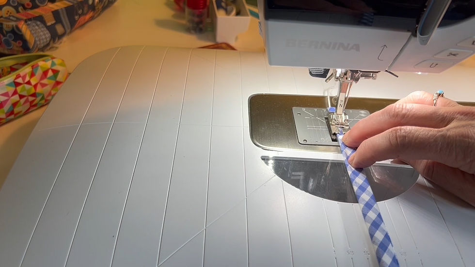 Stitching the bias strip with the piping cord.