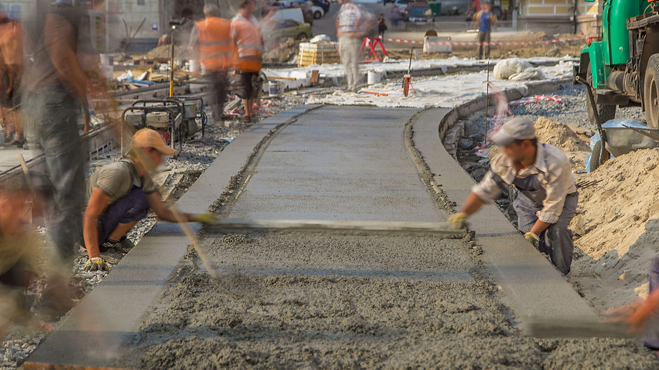 Concrete leveling for road construction site with many workers in uniform timelapse. Recon