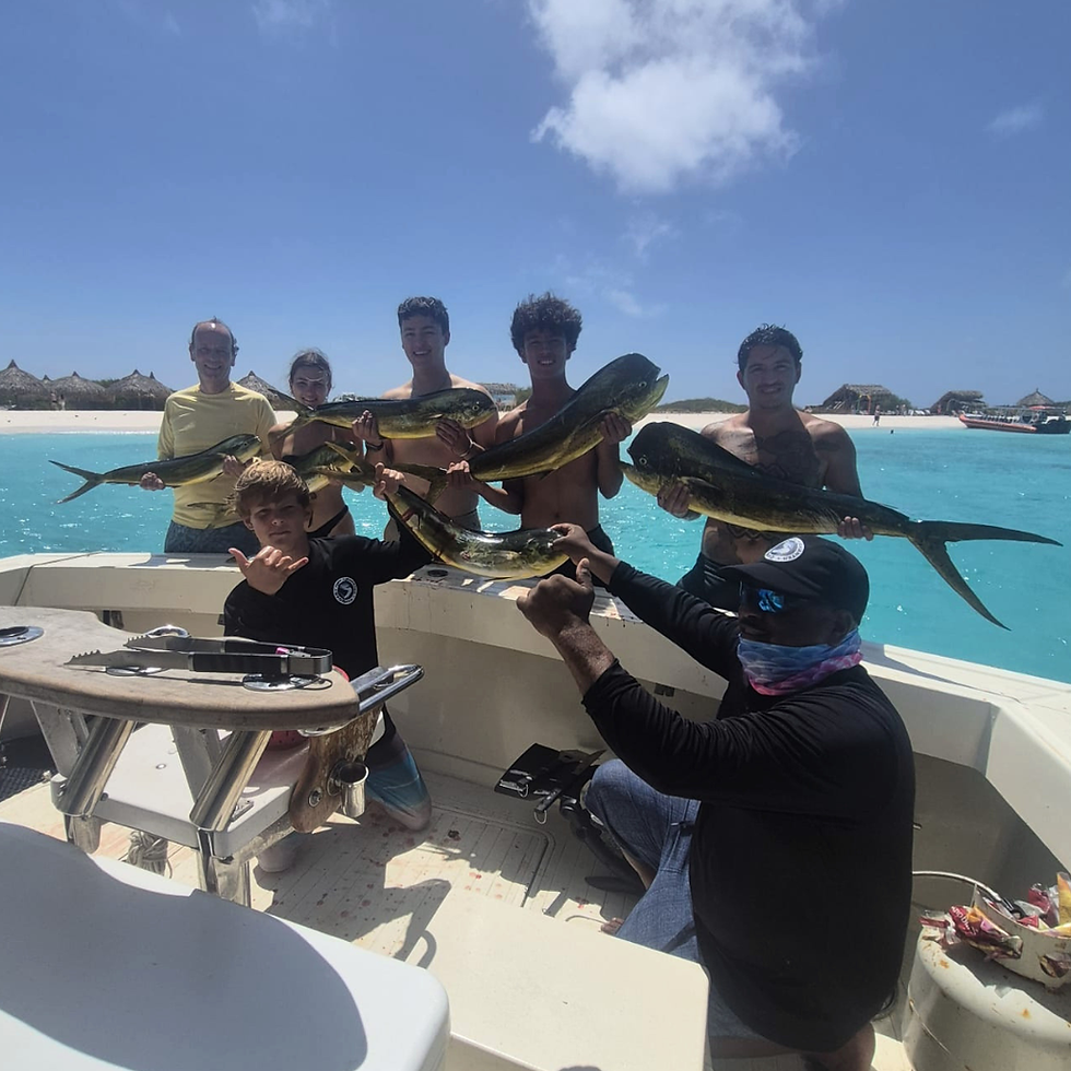 Guests showing mahi mahi during a fishing trip in Curacao