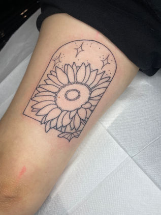 Black linework sunflower tattoo