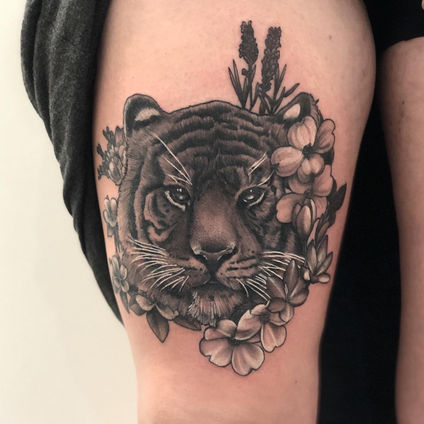 Black and grey neo traditional tiger thigh tattoo with flowers