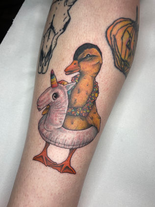 colour neo traditional tattoo of a duckling with a rubber ring 