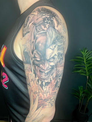 Mixed style comic book tattoo of Batman and the Joker with comic panel background