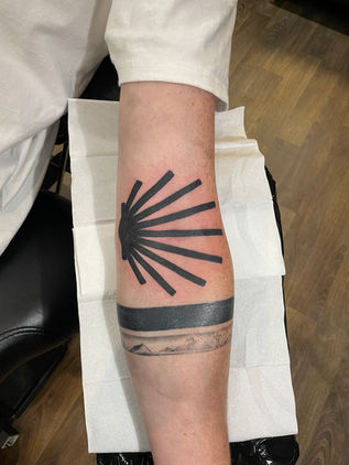 Black sun symbol tattoo