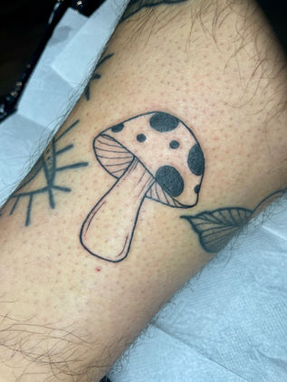 Black freehand linework mushroom tattoo