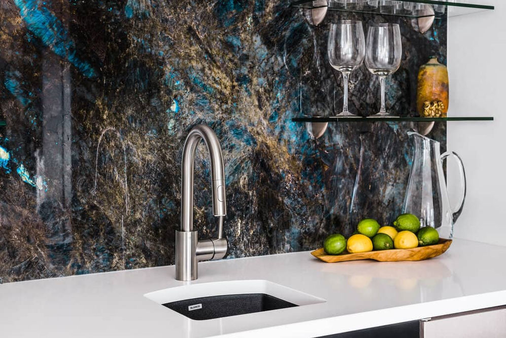 eclectic marble backsplash, white corian countertop, glass shelves