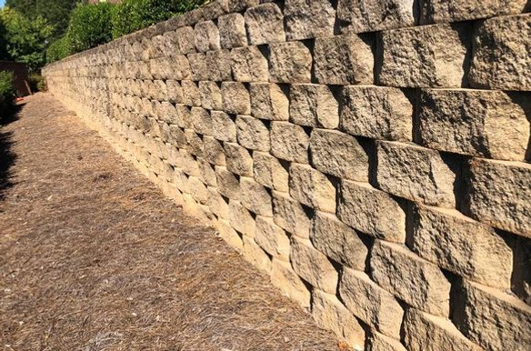 Large light brown concrete block retaining wall