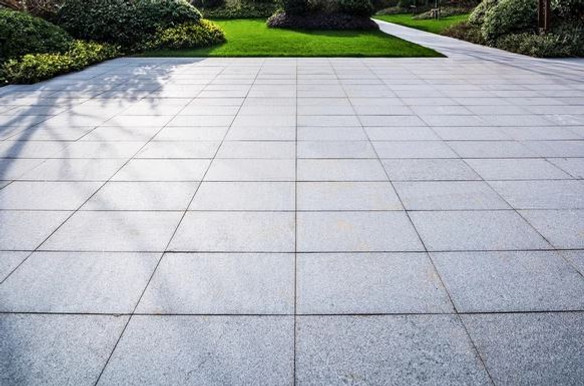 Smooth large square granite patio pavers on residential property