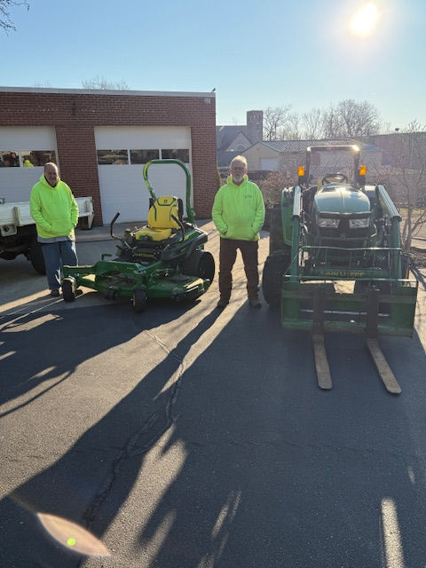Two maintenance workers with equipment
