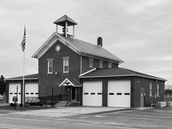 Brick fire station with bell tower and American flag