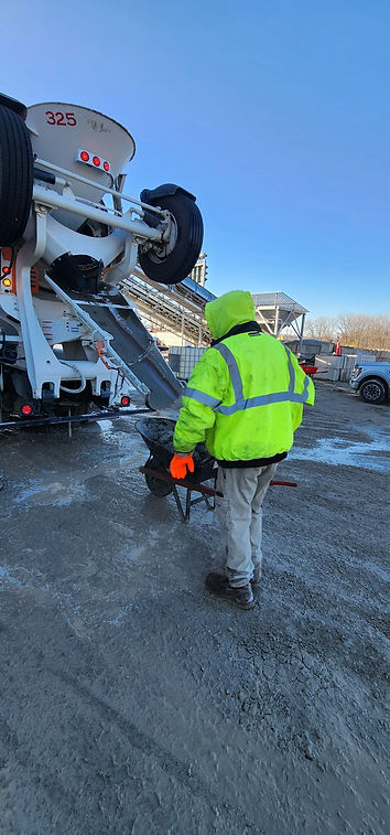 Worker cleaning cement truck