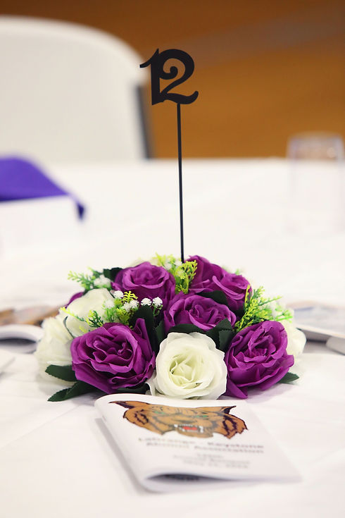 Purple and white floral centerpiece with table number 12