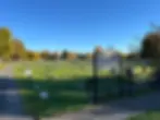 Entrance to LaGrange Cemetery with gravestones and autumn trees