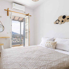Bright bedroom, queen bed, open balcony, modern decor, koukou house skopelos.