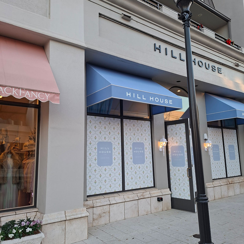 Modern commercial awning installation featuring clean white trim and branded valance for retail storefront